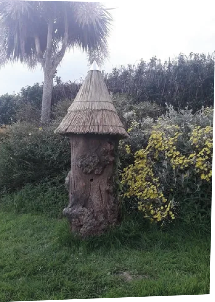 Standing Log hive in a field